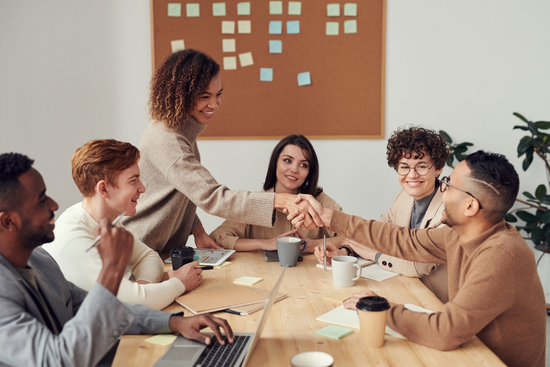 Recruitment professionals meeting and shaking hands around a table